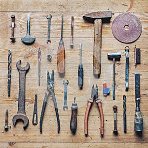 Old dirty vintage repair tools on wooden background