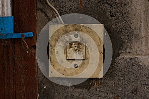 Old dirty white light switch on the wall