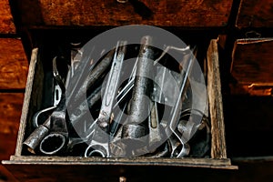 Old dirty wrenches in box close up