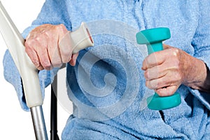 Old disabled lady holding dumbells and crutch
