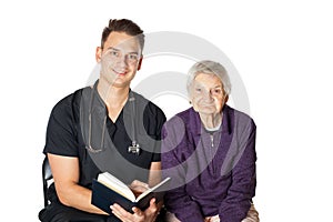 Old woman with carer reading a novel