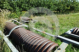 Old disc harrow at the side of a field come orchard