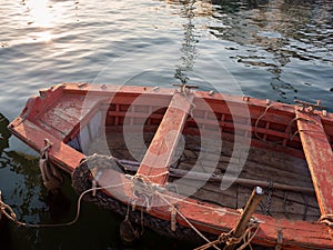 Old discolored red wooden fishing boat.