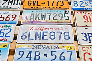 Old discontinued car license plates or vehicle registration numbers from different USA states such as California, Nevada