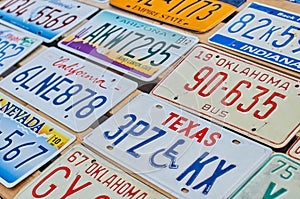 Old discontinued car license plates or vehicle registration numbers from different USA states such as California, Texas