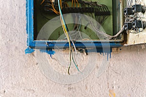 Old dismantled and rusty electrical panel assembly on an abandoned and destroyed factory against a backdrop of chaos.