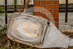 Old dismantled streetlight on ground