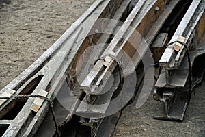Old dismantled tram rails with a turning mechanism lie on the asphalt. Roads and urban economy. Scrap metal