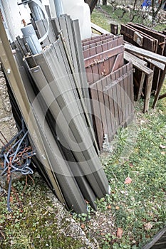 Old disused roller shutters stacked outside the house.