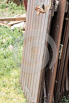 Old, disused wooden slats piled up outside the house. Useless stuff.