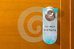 Old Do Not Disturb sign tag haning on metal door knob, concept o