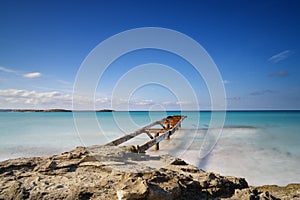 old dock leads out into the turquoise waters of the Ses Illetes Beach in northern Formentera