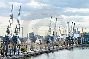 Old Dockside Cranes alongside a Waterfront Development  in London