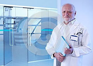 Old doctor standing in MRI room of hospital