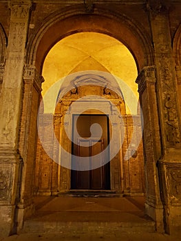 Old door in arcades of Bologna, Emilia-Romagna, Italy