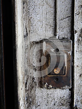 Old Door bell on dirty white wall