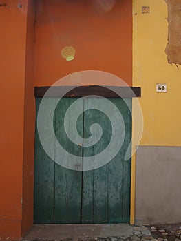 Old door between colored walls