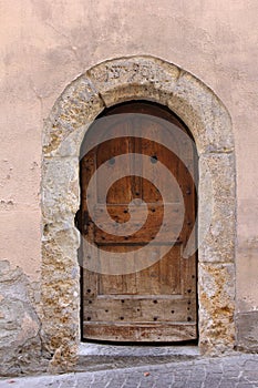 Old door with eroded stone arch