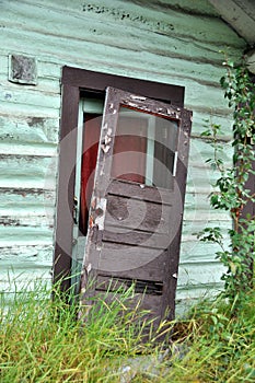 Old Door Falling of Hinges of Historic Cabi photo
