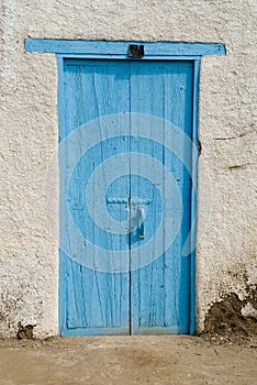 Old door of a farm or rural house painted blue