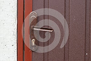 Old door handle on an iron fence close-up