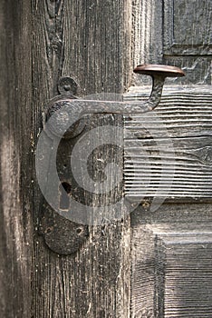 Old door handle on wooden door