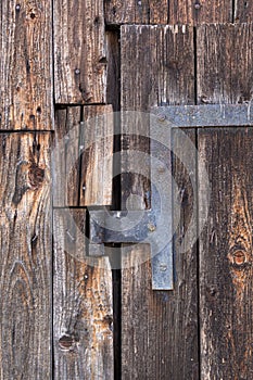 Old door hinge at wooden barn