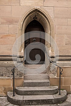 Old door of a historical building with stairway