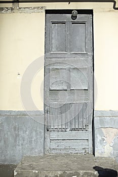 Old door in house. Gray front door in building