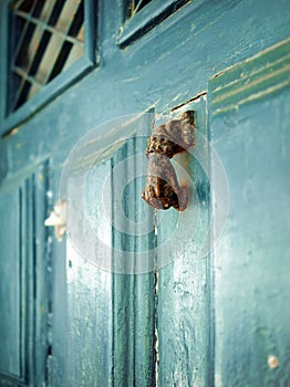 Old door knob (knocker) in the form of a hand photo