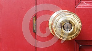 Old door knob on red wood door