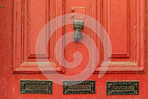 An old red door with on a street in the center of Porto. Portugal photo