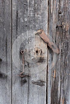 The old door locked with a padlock hanging brackets.