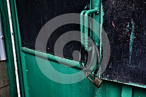 old door locked with rusty padlock