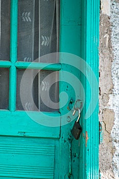 Old door locker open on a wooden door