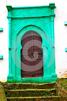 old door in morocco and wall ornate green