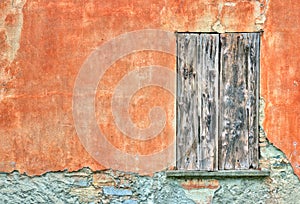 Old door by an orange wall