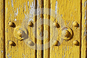 Old door with peeling ochre paint