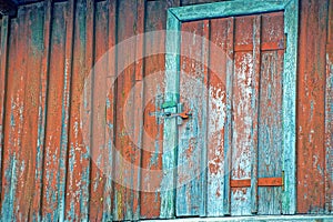 The old door on the red wooden wall
