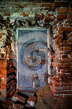 Old door in ruined abandoned prison