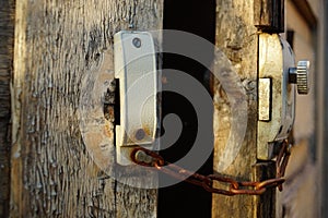 Old door with rusty chain and lock