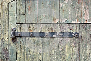 Old door with rusty hinge.