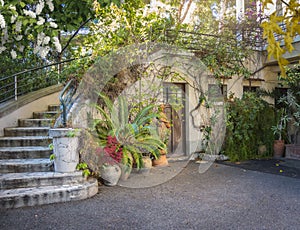 Old door in wall beneath outdoor staircase