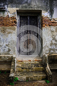 Old door and wall temple in Thailand