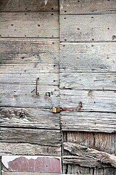 Old door, wood texture, with cracks in the paint and veins of the wood itself