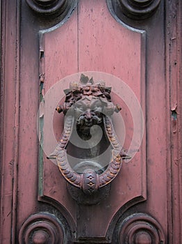 Old doorknocker on pink door