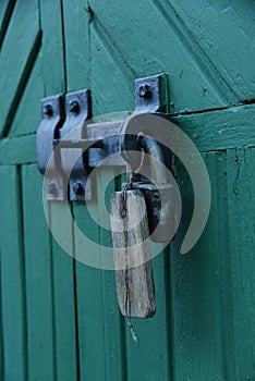 Old doors gates closed with black metall padlock with hasp