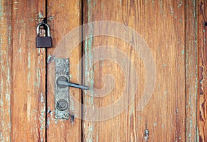 Old doors with rusty door handle and padlock