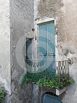 Old doorway, forgotten neglected garden. Italy.