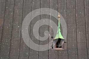 Old dorm window in metal roof of a church